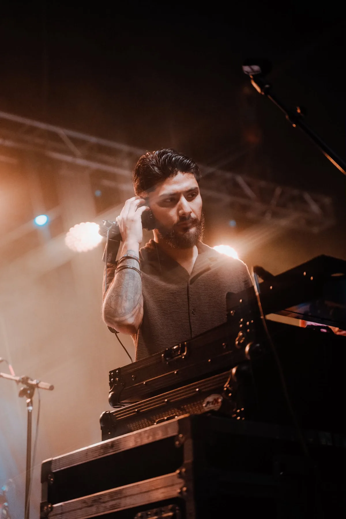 DJ Sarif listening through headphones during a live set